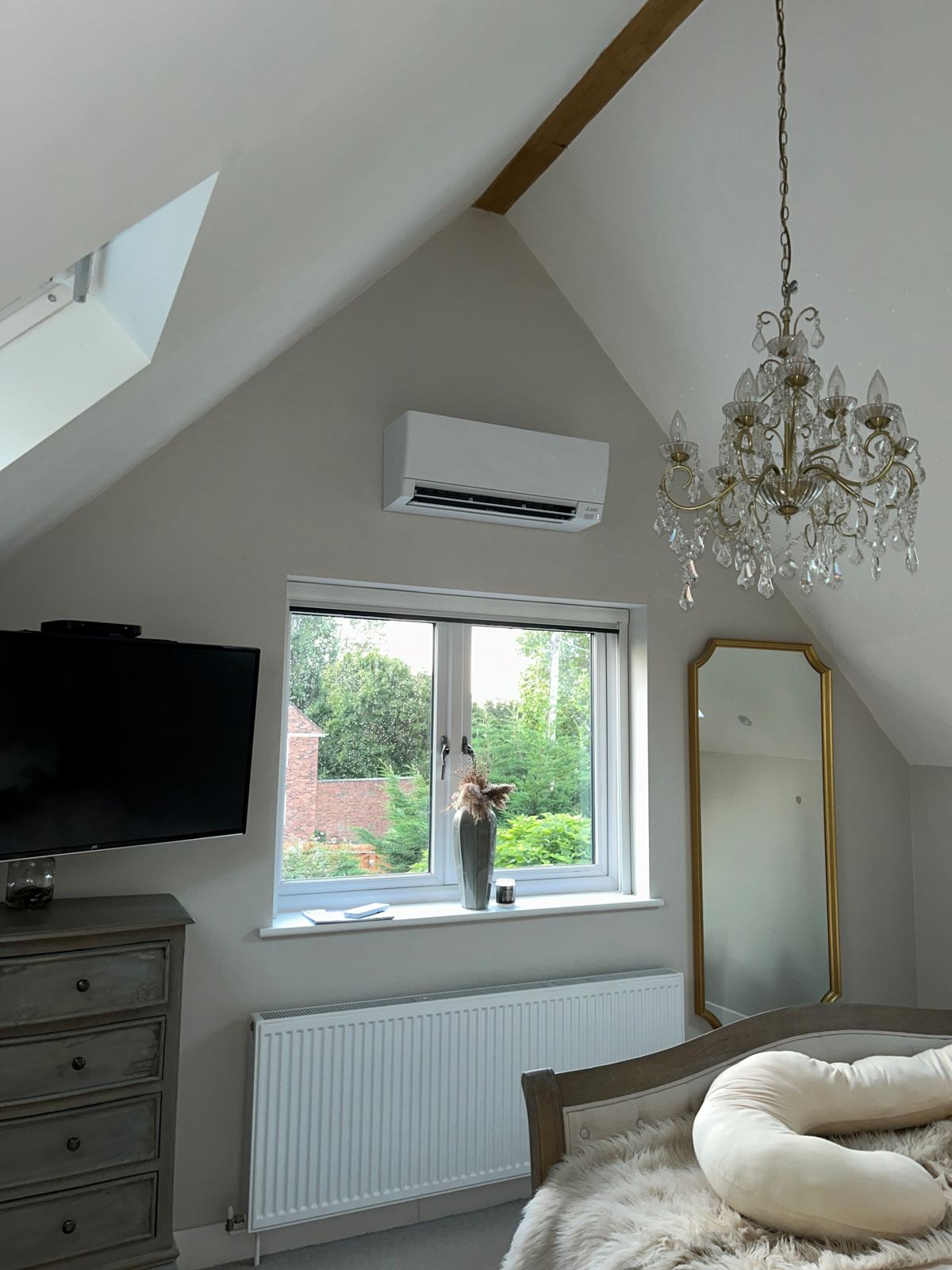 Wall-mounted air conditioning unit in a loft bedroom conversion, Gloucestershire
